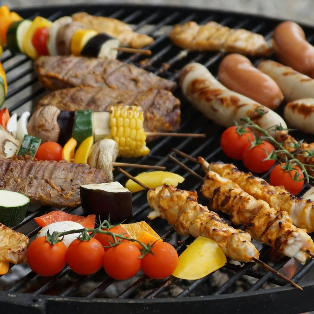 Grillades et légumes cuisant sur le barbecue chez Gourmand.
